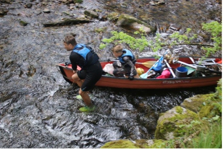 hauling a canoe in the River Erme